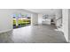 Bright, open living room with tile flooring and sliding glass doors to the backyard at 1979 Longliner Loop, Wesley Chapel, FL 33543