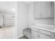This mud room features convenient storage cabinets and a bench with a view to the garage at 1979 Longliner Loop, Wesley Chapel, FL 33543
