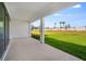 Covered patio showcases a lush green backyard, perfect for outdoor relaxation and entertaining at 1979 Longliner Loop, Wesley Chapel, FL 33543