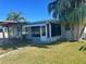 Home features a covered patio and fenced backyard at 2215 Riomar Dr, Holiday, FL 34691