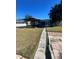 Covered patio and a spacious grassy backyard at 2215 Riomar Dr, Holiday, FL 34691