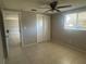 Bedroom with tile floors and sliding door closet at 2215 Riomar Dr, Holiday, FL 34691