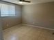 Bedroom with window, tile floor and ceiling fan at 2215 Riomar Dr, Holiday, FL 34691