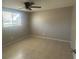 Spacious bedroom with ceiling fan and tile flooring at 2215 Riomar Dr, Holiday, FL 34691