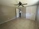 Bright bedroom with tile flooring, ceiling fan, and mirrored closet doors at 2215 Riomar Dr, Holiday, FL 34691