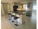Updated kitchen features a breakfast bar, modern appliances, and stylish tile flooring at 2215 Riomar Dr, Holiday, FL 34691