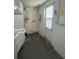 Laundry room with exterior access and shelving at 2215 Riomar Dr, Holiday, FL 34691