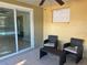 Covered patio with wicker chairs and small table at 2215 Riomar Dr, Holiday, FL 34691