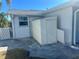 White vinyl shed in the backyard for extra storage at 2215 Riomar Dr, Holiday, FL 34691