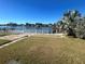 Private backyard oasis with canal views and a white fence at 2215 Riomar Dr, Holiday, FL 34691