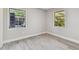 Bedroom with wood-look floors and two windows at 2412 38Th W Ave, Bradenton, FL 34205