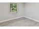 Simple bedroom with a window and wood-look floors at 2412 38Th W Ave, Bradenton, FL 34205