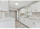 Modern kitchen featuring white shaker cabinets, quartz countertops, and stainless steel appliances at 2412 38Th W Ave, Bradenton, FL 34205