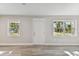 Bright living room featuring neutral walls, wood-look flooring, and multiple windows at 2412 38Th W Ave, Bradenton, FL 34205