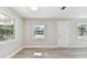 Bright living room with neutral walls, wood-look flooring, and multiple windows at 2412 38Th W Ave, Bradenton, FL 34205