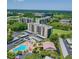 Stunning aerial view of condo buildings, landscaping, and a sparkling blue swimming pool at 2617 Cove Cay Dr # 505, Clearwater, FL 33760
