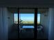 Enjoy serene views of the water from this cozy balcony with a table and chairs at 2617 Cove Cay Dr # 505, Clearwater, FL 33760