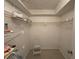 Spacious walk-in closet features ample shelving for organized storage with neutral walls and flooring at 2617 Cove Cay Dr # 505, Clearwater, FL 33760
