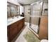 Clean bathroom with double vanity and a walk-in shower at 2912 W Main St, Tampa, FL 33607