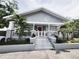 Charming house with gray siding, a white porch, and landscaped yard at 2912 W Main St, Tampa, FL 33607