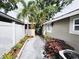 Side yard with concrete path and landscaping at 2912 W Main St, Tampa, FL 33607