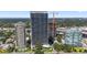 Aerial view of a modern highrise building complex with pools and landscaping at 2912 W Santiago St # 404, Tampa, FL 33629