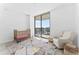 Serene Bedroom with a crib, recliner, and access to a balcony at 2912 W Santiago St # 404, Tampa, FL 33629