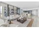 Open living room with modern furniture and kitchen access at 2912 W Santiago St # 404, Tampa, FL 33629