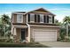 Two-story home with neutral siding, shutters, and a two-car garage at 31210 Pendleton Landing Cir, Wesley Chapel, FL 33545