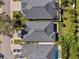 Aerial view of neighboring homes and in-ground pools with screen enclosures at 34 Concord Dr, Dunedin, FL 34698