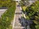 Aerial view of Dunedin Cove entry gate with palm trees and tropical landscaping at 34 Concord Dr, Dunedin, FL 34698