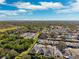 Expansive aerial view of the neighborhood showcases the community's layout and surrounding greenery at 34 Concord Dr, Dunedin, FL 34698