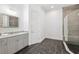 Modern bathroom featuring a vanity with marble countertop, and a tiled walk-in shower at 34 Concord Dr, Dunedin, FL 34698