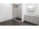 Modern bathroom featuring a walk-in shower with glass enclosure and a vanity with gray cabinets at 34 Concord Dr, Dunedin, FL 34698