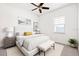 Bright bedroom with a ceiling fan, a large window, and neutral decor with a modern style at 34 Concord Dr, Dunedin, FL 34698