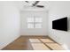 Well-lit bedroom with hardwood floors, neutral paint, and a window at 34 Concord Dr, Dunedin, FL 34698