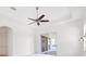 Spacious bedroom with ceiling fan and sliding doors, providing access to the lanai at 34 Concord Dr, Dunedin, FL 34698