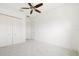 Spacious empty bedroom with a ceiling fan and a large closet, ready for personalization at 34 Concord Dr, Dunedin, FL 34698