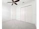 Spacious empty bedroom with a ceiling fan and a large closet, ready for personalization at 34 Concord Dr, Dunedin, FL 34698