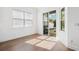 Bright flex room with wood floors, sliding glass door, and view of the outdoor grill at 34 Concord Dr, Dunedin, FL 34698