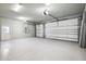 Spacious three-car garage with epoxy flooring and ample storage space for vehicles and equipment at 34 Concord Dr, Dunedin, FL 34698