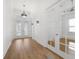Hallway features hardwood floors, natural light, with glass doors leading to another room at 34 Concord Dr, Dunedin, FL 34698