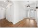 Light-filled hallway with light hardwood floors and neutral paint at 34 Concord Dr, Dunedin, FL 34698
