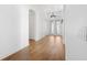 Hallway featuring hardwood floors and decorative lighting, leading to double doors at 34 Concord Dr, Dunedin, FL 34698