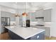 Spacious kitchen with a large center island, stainless steel appliances, and custom cabinetry at 34 Concord Dr, Dunedin, FL 34698