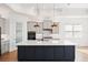 Open-concept kitchen featuring a center island, pantry, and modern appliances at 34 Concord Dr, Dunedin, FL 34698