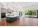 Open kitchen with island, modern appliances, and access to the outdoor pool at 34 Concord Dr, Dunedin, FL 34698