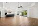 Spacious open-concept living room connects to the kitchen with sliding glass doors to outdoor pool area at 34 Concord Dr, Dunedin, FL 34698