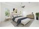 Stylish main bedroom with tray ceilings, a ceiling fan, large windows, and contemporary decor at 34 Concord Dr, Dunedin, FL 34698