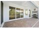 Covered patio area with outdoor grill and sliding glass doors to indoor living space at 34 Concord Dr, Dunedin, FL 34698